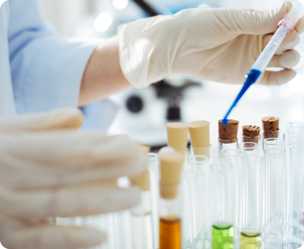 Scientist handling test tubes in a lab setting.
