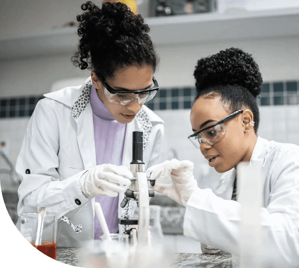 Two scientists in a lab conducting an experiment with a microscope.